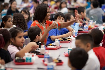 First Lady Michelle Obama joins children for lunch at Parklawn Elementary School in Alexandria, Va., Jan. 25, 2012. Mrs. Obama was joined by Agriculture Secretary Tom Vilsack and celebrity cook Rachael Ray for a Let's Move! event celebrating the school’s food service employees serving healthy meals that meet the U.S. Department of Agriculture’s