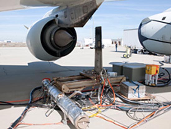 1-An emissions detection rake device is positioned behind the No.3 engine on NASA's DC-8 flying laboratory during ground tests of an alternative jet fuel made from chicken and beef tallow. (NASA / Tom Tschida)