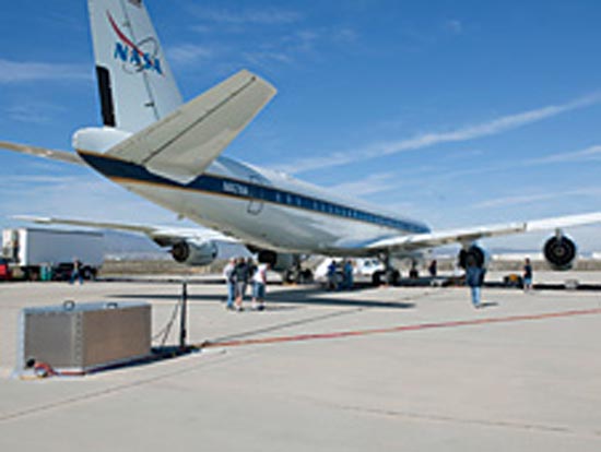 2- Researchers check out emissions detection equipment set up behind NASA's DC-8 flying laboratory during ground tests of alternative biofuels derived from animal fats at the Dryden Aircraft Operations Facility in Palmdale, Calif. (NASA / Tom Tschida)